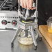 A person using a Nemco Easy Chopper to dice vegetables on a counter.