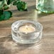 A Sterno tealight candle in a clear glass holder.