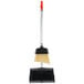 A Unger angled lobby broom and dustpan with a red handle.