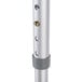 A silver metal Unger telescopic pole with holes in it.