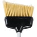 An Unger black and gold angled lobby broom with long bristles.