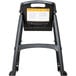 A black Rubbermaid high chair with a yellow label.