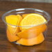 a close up of a bowl of orange slices