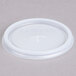 A translucent plastic Cambro lid with a straw slot.