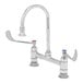 A chrome T&S deck mounted faucet with gooseneck nozzle and lever handles.