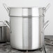 A large silver Vollrath stainless steel double boiler pot on a stove.