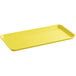 A yellow rectangular Cambro market tray with a handle.