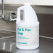 A white jug of Advantage Chemicals Concentrated Pot & Pan Liquid Detergent with a blue label.