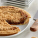A slice of Golden Barrel Shoofly Pie on a plate with a knife and fork.