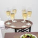 A waiter holding a Cambro non-skid serving tray with glasses of champagne.