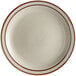 a white plate with a brown rim