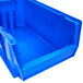 A blue plastic Metro stack bin with a handle.