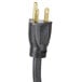 A close-up of a black plug on a black and gold power cord.