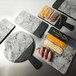 An Elite Global Solutions marble round serving board with food on it.