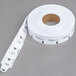 A white roll of Turn-O-Matic take a number tickets with numbers on it.