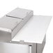 A white cutting board on a stainless steel counter.