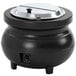 A black Vollrath Colonial kettle with a silver lid on a countertop.