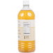 A close-up of a bottle of orange liquid.