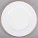 A white porcelain plate with a gold rim.