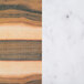 A close-up of an Elite Global Solutions faux hickory wood and Carrara marble rectangular serving board.