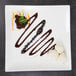 A 10 Strawberry Street white porcelain square platter with chocolate drizzled with blueberries.