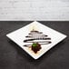 A 10 Strawberry Street white porcelain square coupe platter with a chocolate dessert topped with ice cream and chocolate sauce.