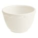 An Acopa ivory stoneware bouillon cup with a scalloped edge and a silver handle.