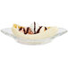A Libbey glass bowl with a banana split topped with whipped cream and chocolate syrup.