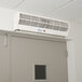 A white Curtron air curtain above a door.
