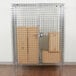 A Metro chrome wire security cabinet with boxes inside.