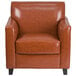 A Flash Furniture brown leather chair with wooden legs.