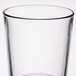 A close-up of a Libbey stackable cooler glass with a black rim.