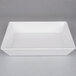 A white rectangular American Metalcraft melamine serving bowl on a gray surface.