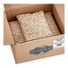 A cardboard box filled with Dried Small Lima Beans.