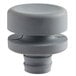 A grey plastic knob with a round top.