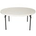 a white round table with black legs