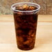 A Fabri-Kal Greenware plastic cup filled with a brown liquid and ice.