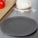 A ball of pizza dough on an American Metalcraft hard coat anodized aluminum pizza pan.