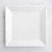 An Acopa bright white square porcelain plate on a white surface.