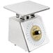 An Edlund stainless steel portion scale with a white dial on a counter.