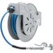 An open epoxy coated steel T&S hose reel with a hose attached to it.