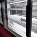 A red Turbo Air curved glass refrigerated bakery display case with glass doors.