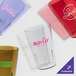 A group of clear Cambro plastic tumblers with custom text.