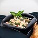 A black GET Geneva bowl filled with pasta and broccoli on a table.