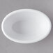 a white bowl on a gray surface