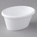 A white Carlisle oval ramekin on a gray surface.