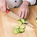 a person cutting cucumbers on a cutting board