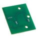 A green circuit board with many holes.