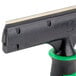 A close-up of a black and green Unger ErgoTec Glass Scraper handle.