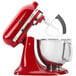 A close-up of a KitchenAid stand mixer using a KitchenAid Flex Edge Flat Beater.